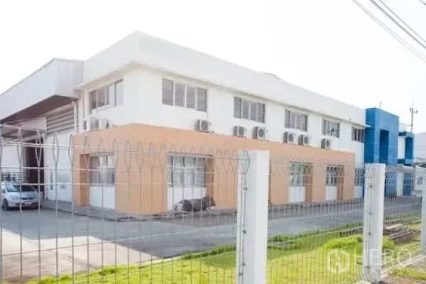 Factory for rent in Chachoengsao - Side view of two-storey office block with multiple air-conditioning units.