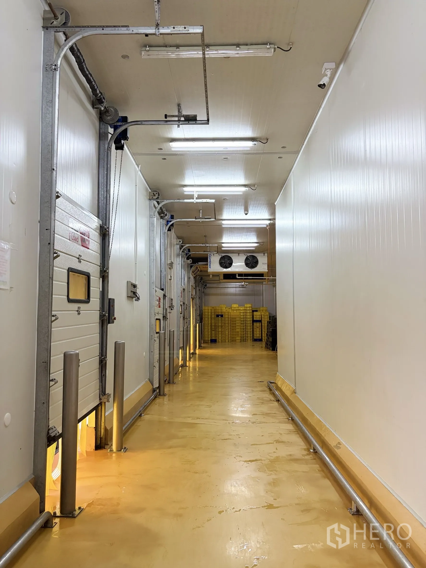 Factory for sale in Mueang Nakhon Pathom, Nakhon Pathom - Interior corridor of cold storage with insulated doors and cooling units.