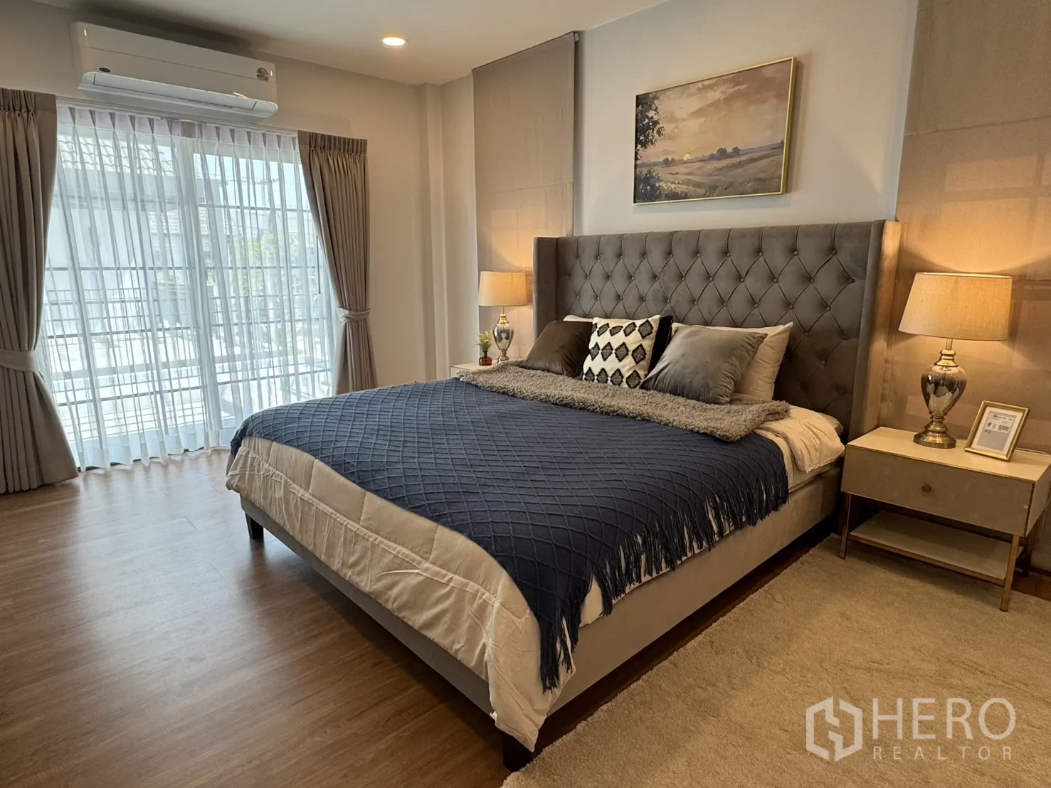 Detached House for rent in Bang Phli, Samut Prakan - Bright bedroom with sheer curtains, balcony access, upholstered headboard and bedside lamps.