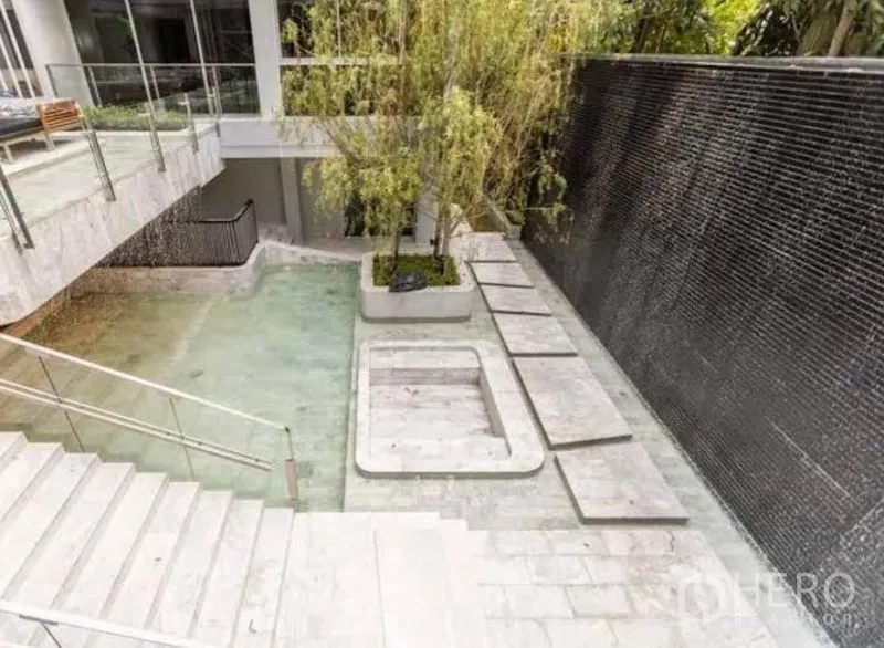 Condominium for rent in Watthana, Bangkok - Aerial view of landscaped water garden with stepping stones and planters.