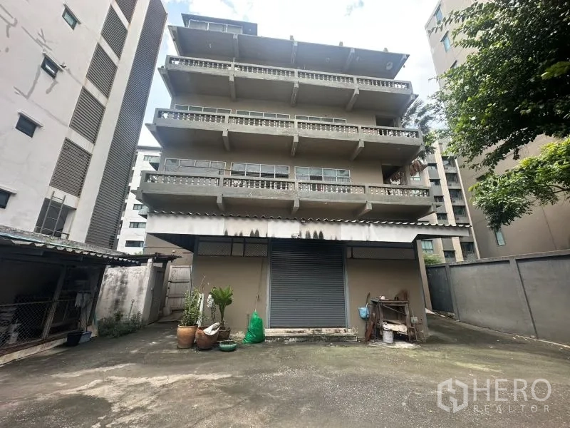 Office Space for rent - Rear elevation of multi-storey office with roller shutter and loading area
