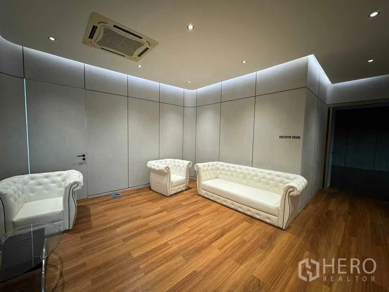 Home Office for rent or sale in Bang Phli, Samut Prakan - Executive lounge featuring white sofas, wood flooring and concealed lighting.