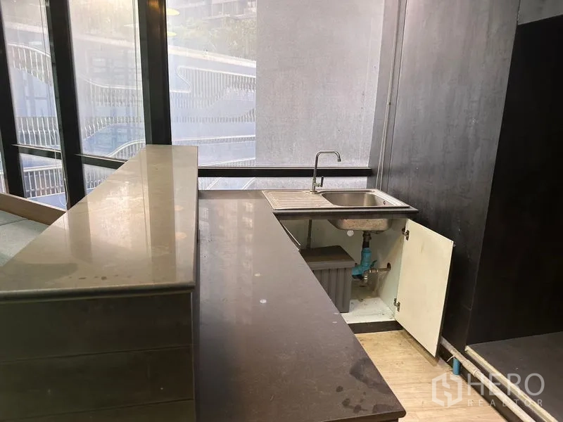办公空间 出租在Din Daeng, Bangkok - 小型茶水间，石材台面、水槽与下部柜体，靠窗。