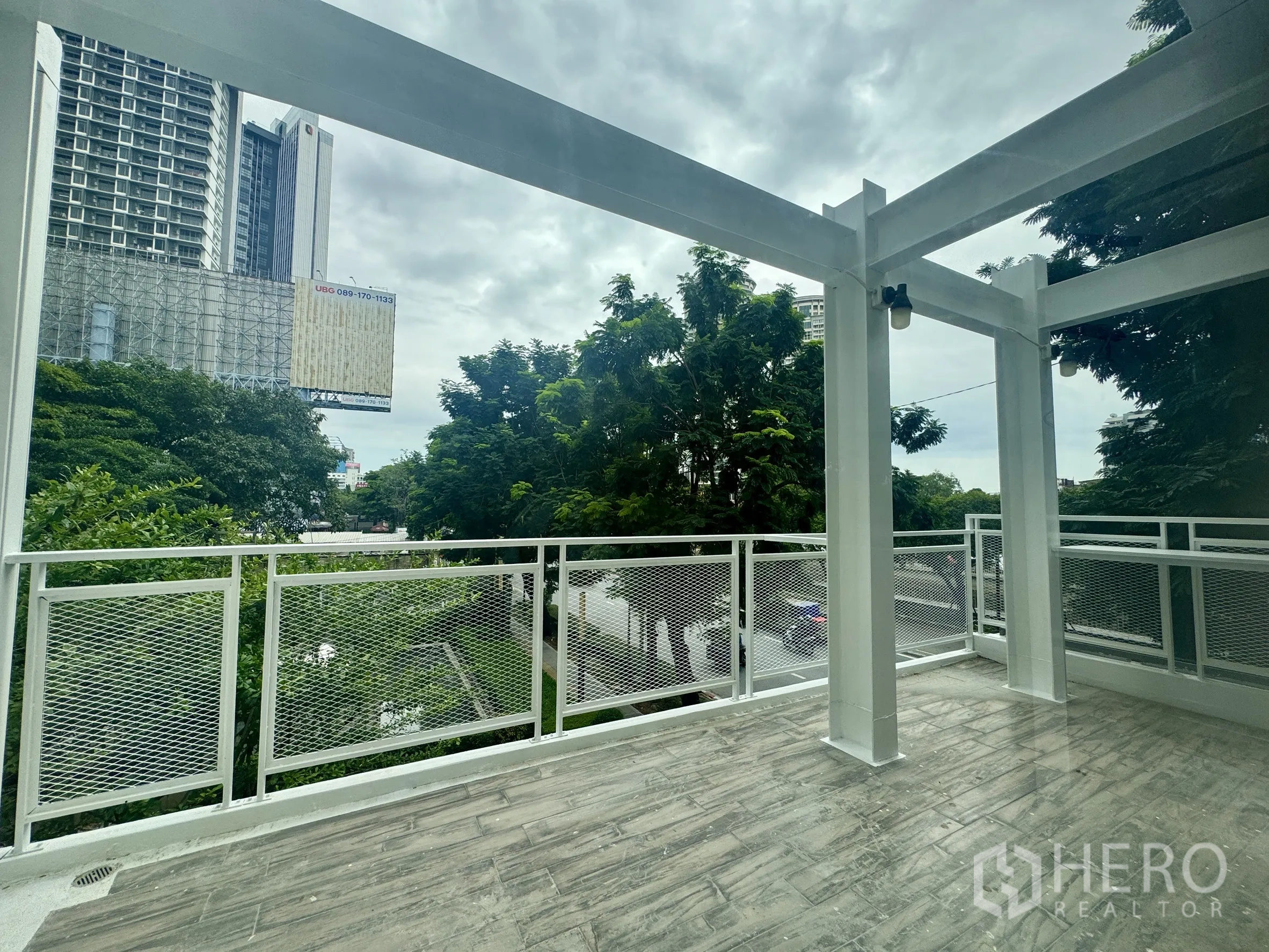 Office Space for rent in Sathon, Bangkok - Large covered terrace with metal railing overlooking trees and city skyline near BTS Chong Nonsi.