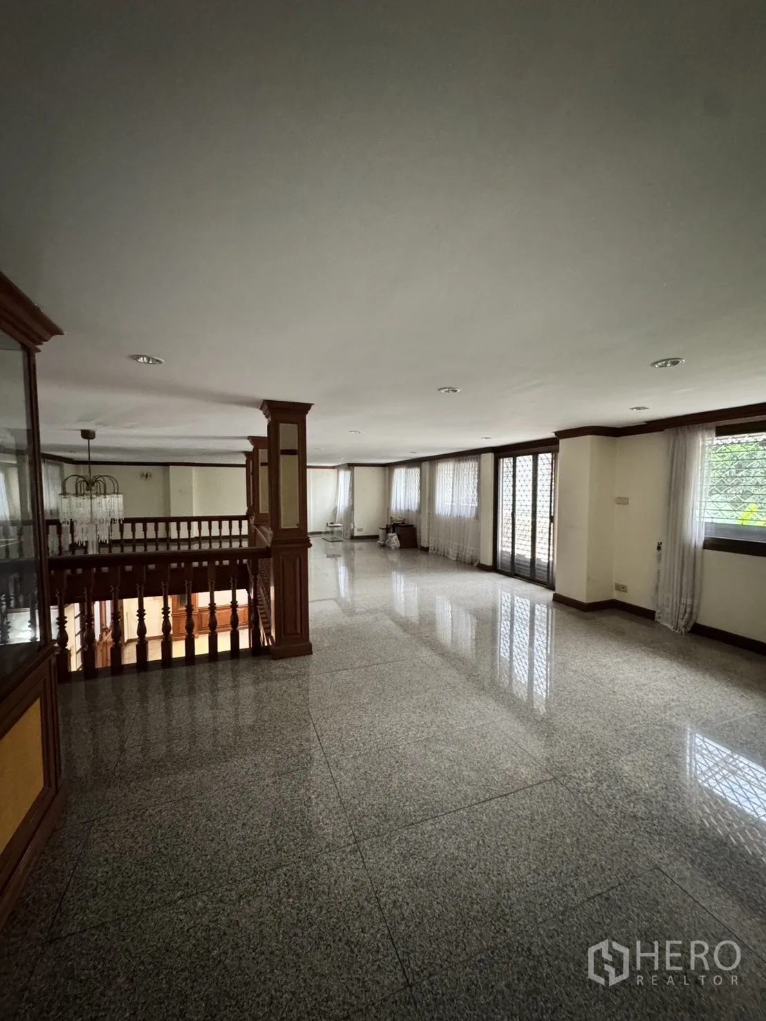 Home Office for rent in Watthana, Bangkok - Grand reception hall with gleaming granite floors, wooden staircase, and pillars.