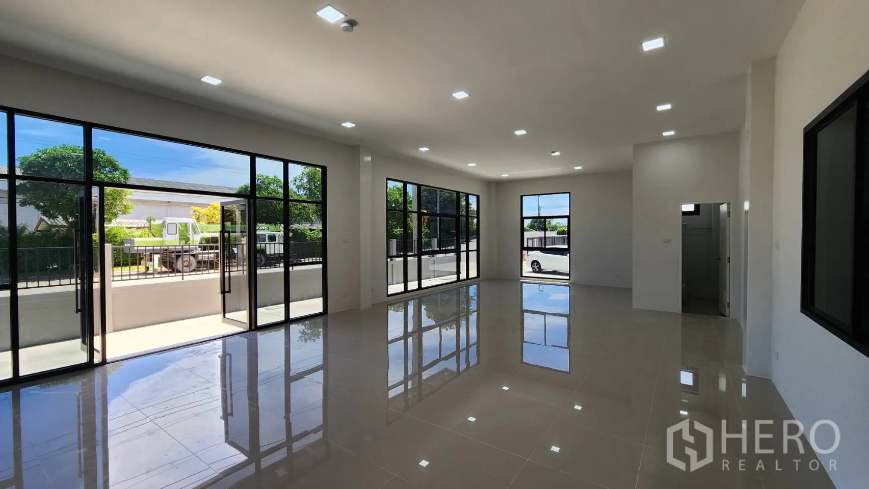 Factory for rent or sale in Bang Bo, Samut Prakan - Clean restroom with shower area, white wall tiles and modern fixtures.