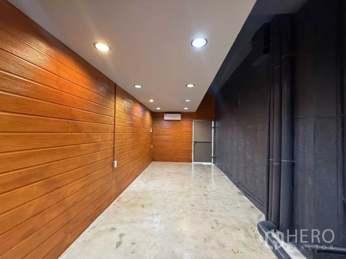 Office Space for rent in Wang Thonglang, Bangkok - Wood-panel accent corridor with downlights and wall-mounted air conditioner.