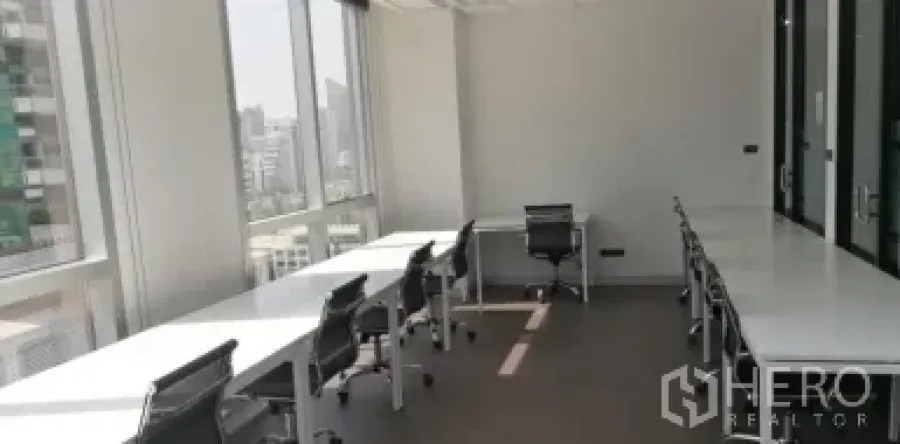 Office Space for rent in Khlong Toei, Bangkok - Row of workstations beside big windows providing strong natural light and urban views.