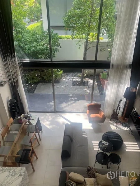 Townhouse for rent - View from mezzanine over the living area to the courtyard through tall glazing