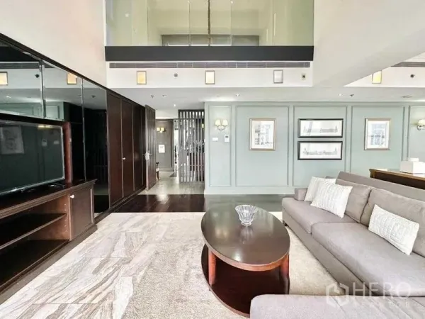 Condominium for rent - Spacious lounge with sectional sofa, media wall and mezzanine ceiling details.