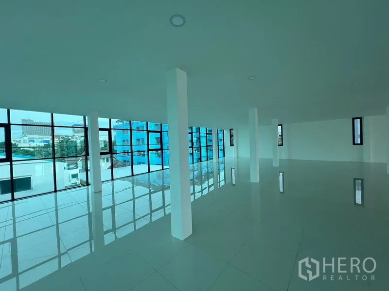 Office Space for rent or sale in Wang Thonglang, Bangkok - Upper-floor office with floor-to-ceiling windows and a city outlook.