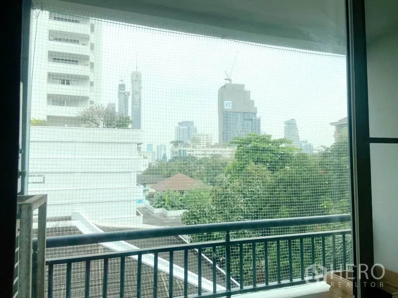 Condominium for rent in Watthana, Bangkok - Balcony outlook over greenery and Bangkok skyline from a mid-floor condo.