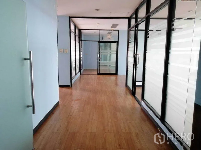 Office Space for rent in Bueng Kum, Bangkok - Hallway lined with glass partitions and frosted panels creating private offices.