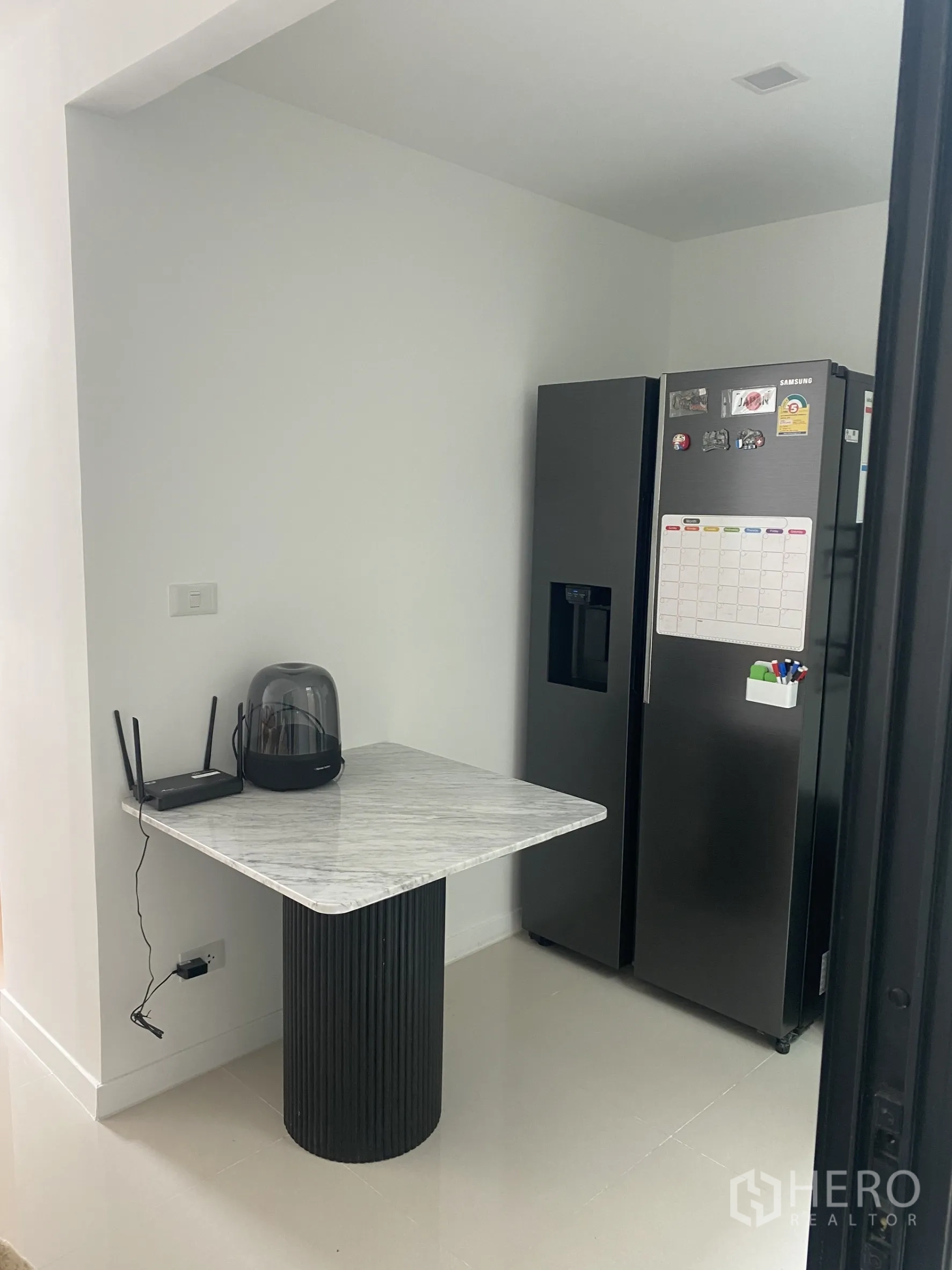 Townhouse for rent or sale in Bang Khae, Bangkok - Pantry nook with marble table and black double-door refrigerator