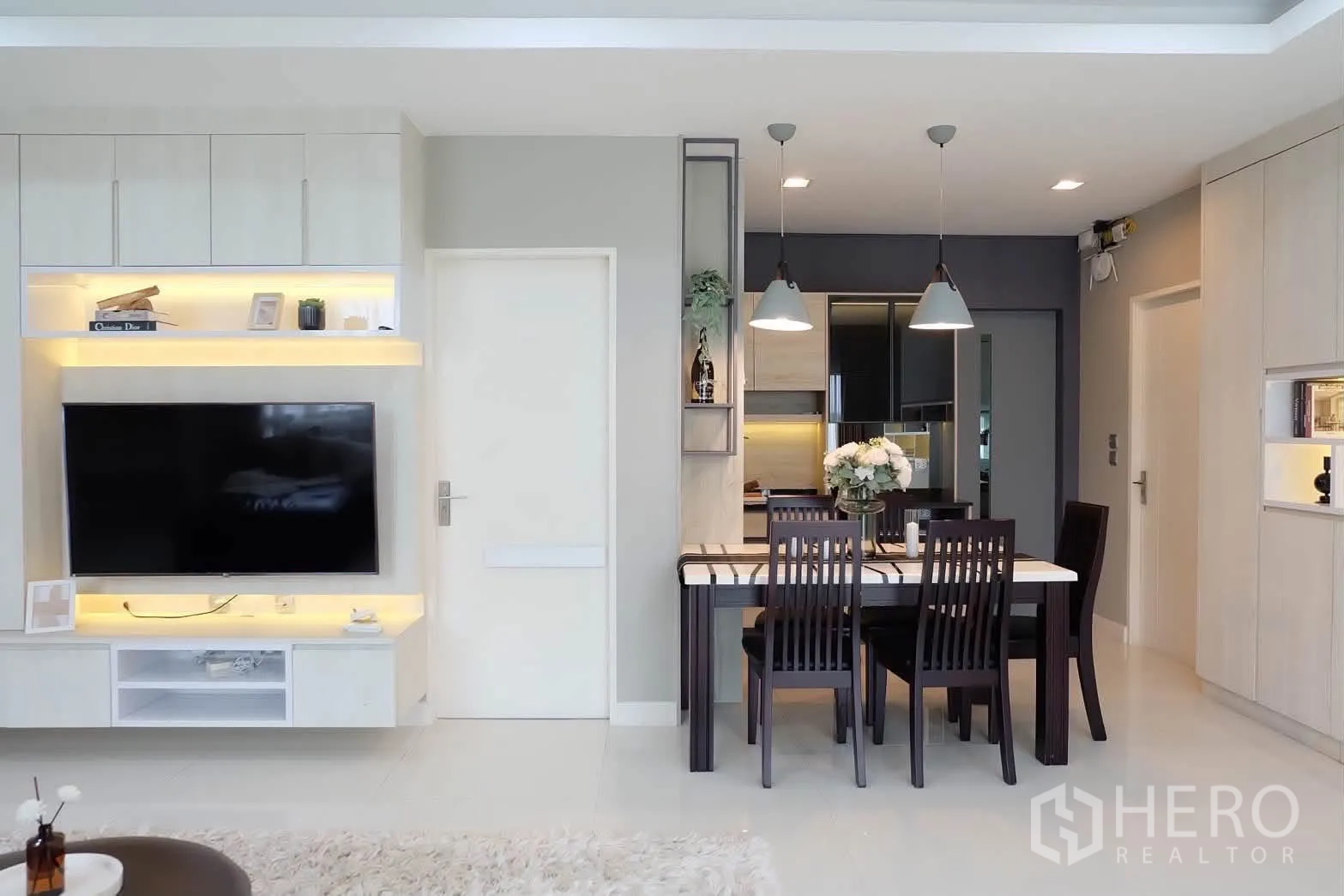 Detached House for rent in Bang Phli, Samut Prakan - TV feature wall beside dining table with pendant lamps.