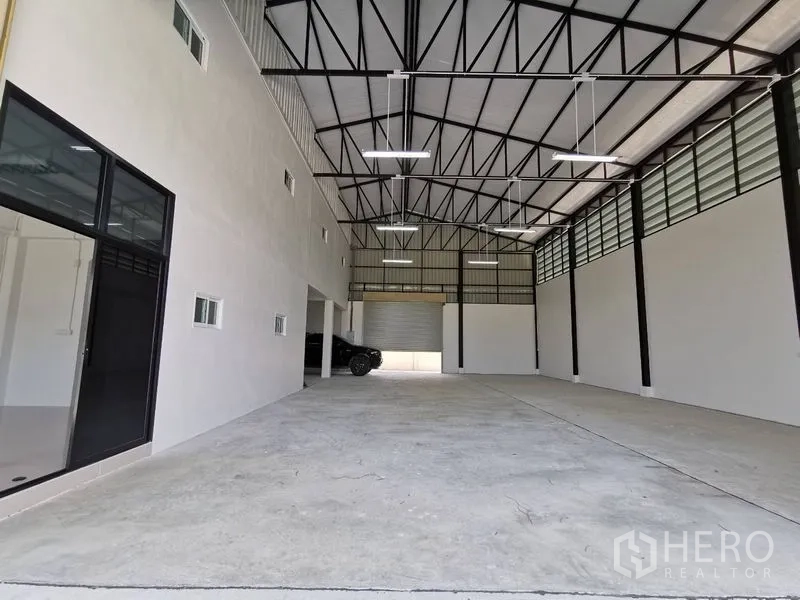 คลังสินค้า ให้เช่าในBang Kruai, Nonthaburi - มุมมองยาวภายในโกดัง มีออฟฟิศกั้นกระจก และประตูม้วนสองด้าน