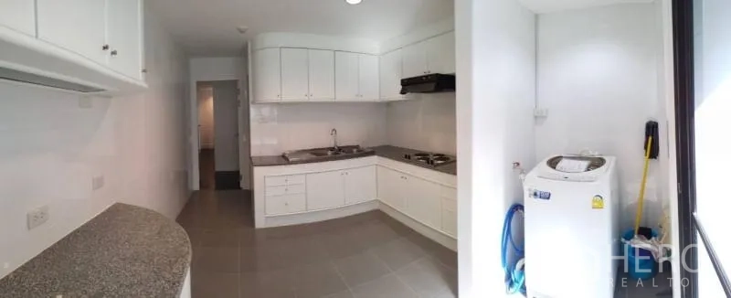 Condominium for rent in Sathon, Bangkok - Panoramic view of spacious kitchen with ample cabinetry and double sink.