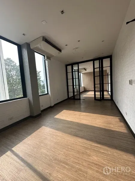 Office Space for rent - Private office room with wood-look flooring, air-conditioning, and glass partitions.