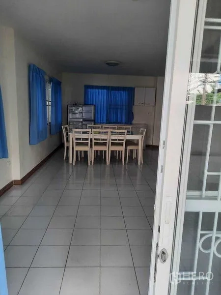 Home Office for rent in Watthana, Bangkok - View from entrance into dining room with table and blue curtains.