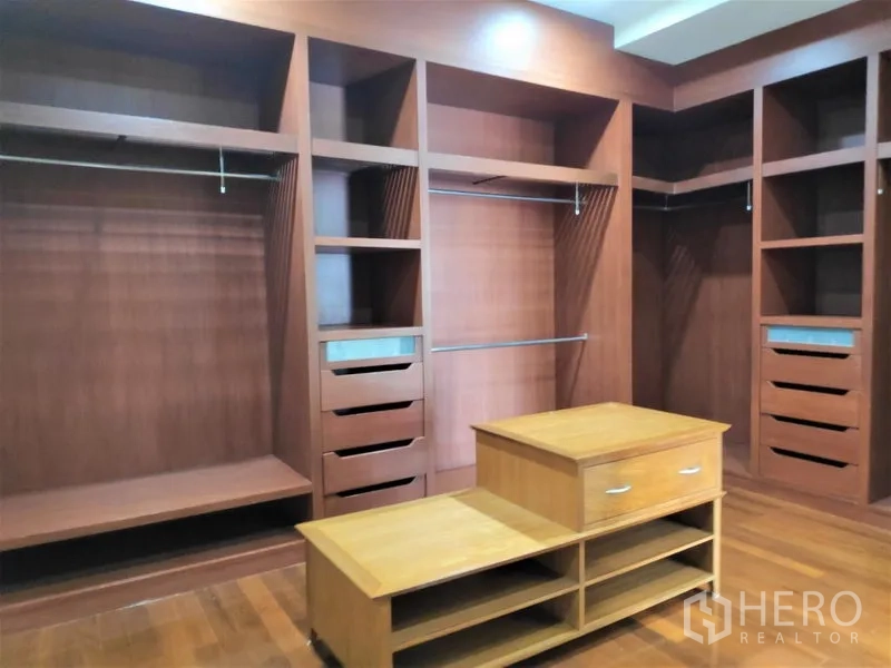 独立式住宅 出租在Watthana, Bangkok - 定制步入式衣帽间，大量木质柜体与抽屉，中置岛台。