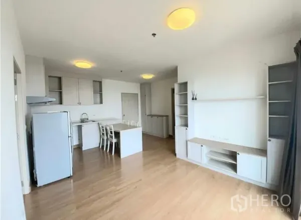 Condominium for sale - Bright open-plan living and kitchen with island, wood floors, built-in shelving and large windows.
