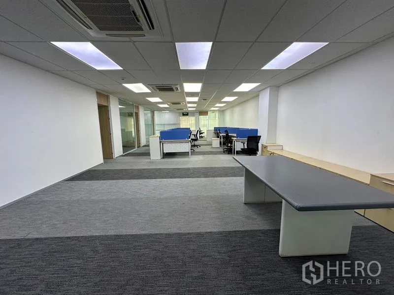 Office Space for rent - Spacious open workspace with multiple workstation clusters and suspended ceiling lights.