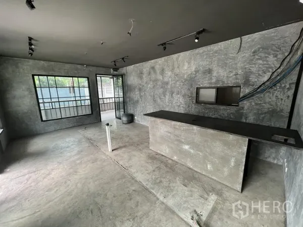 零售空间 出租在Watthana, Bangkok - 开放式店铺空间，水泥墙面、大窗与吧台，待装修。