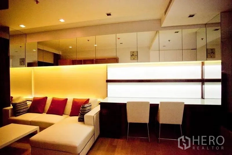 Condominium for rent or sale in Watthana, Bangkok - Workstation for two beside an illuminated feature wall and mirrored panels.