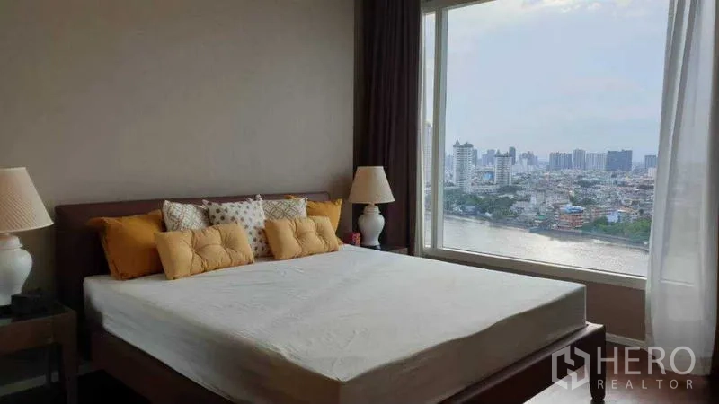 Condominium for rent in Bang Kho Laem, Bangkok - Bedroom with large window and sweeping river and city views.