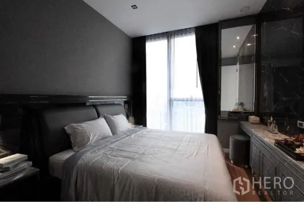 Condominium for rent in Bangkok - Stylish 1-bedroom condo bedroom with upholstered bed, floor-to-ceiling window and dark tones in Bang Kho Laem, Bangkok.