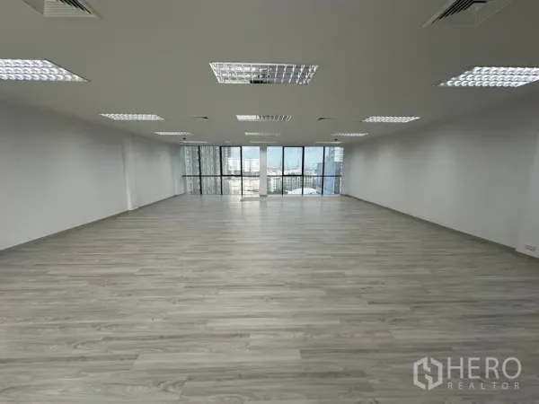 Office Space for rent - Spacious office floor featuring floor-to-ceiling windows, suspended ceiling lights and skyline views