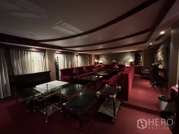 Retail Space for rent in Watthana, Bangkok - Dim lounge with red velvet seating, multiple coffee tables and ambient lighting.