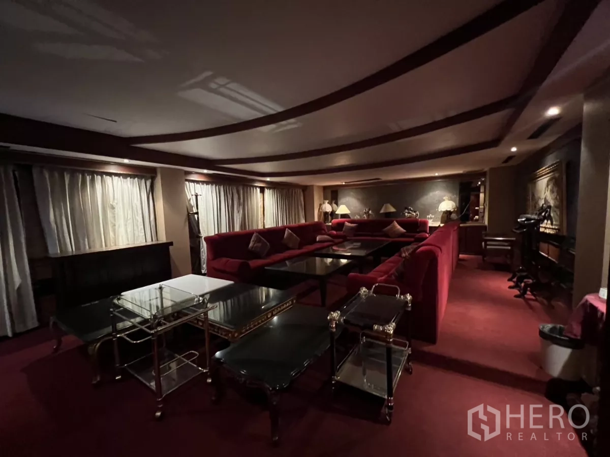 Retail Space for rent in Watthana, Bangkok - Dim lounge with red velvet seating, multiple coffee tables and ambient lighting.