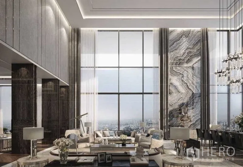 Condominium for sale in Bangkok - Grand double-height living room with full-height glazing and marble accent wall.