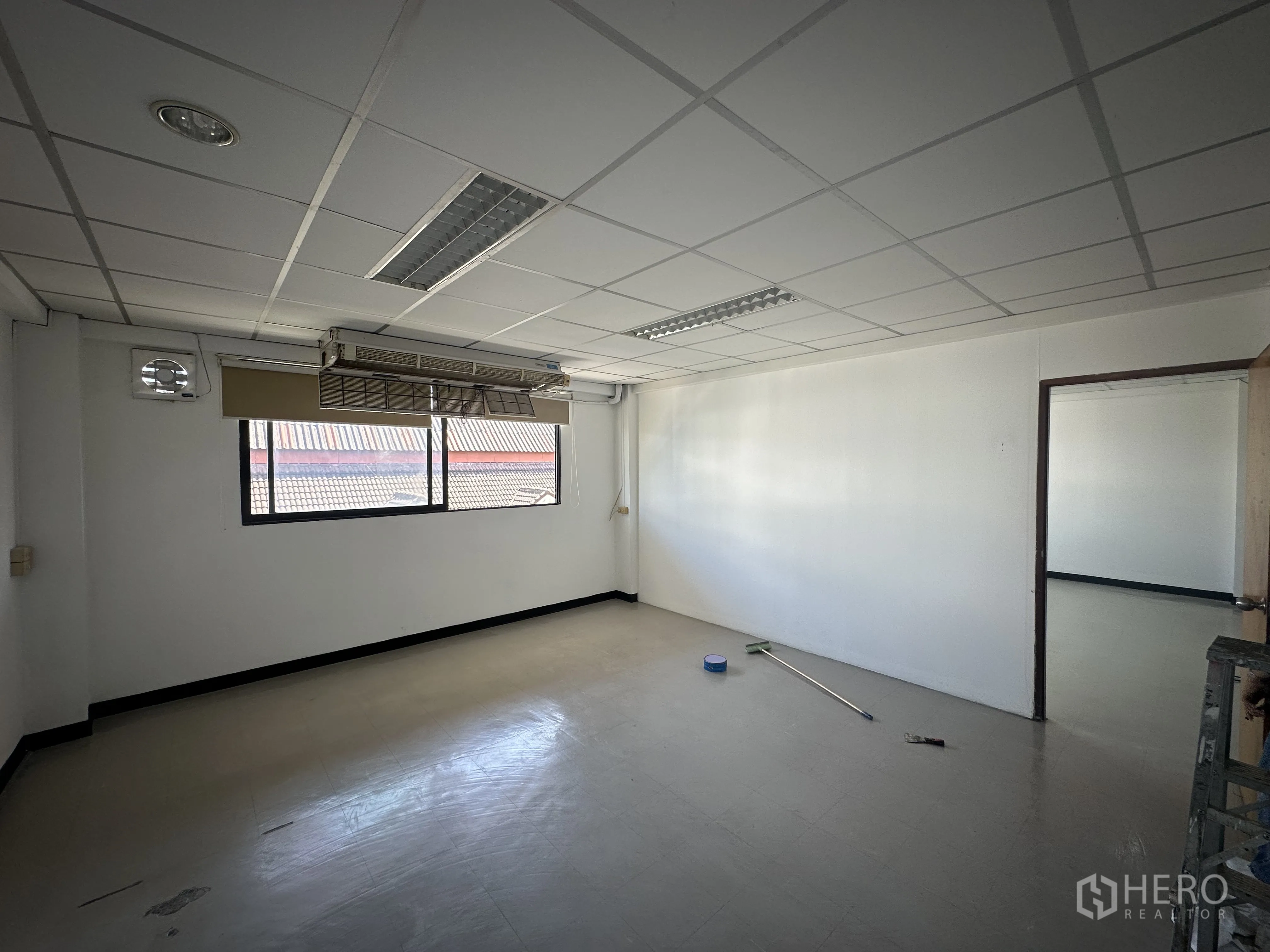 Office Space for rent in Watthana, Bangkok - Private office room with wide window, roller blind, ceiling lighting and a doorway to the main workspace.