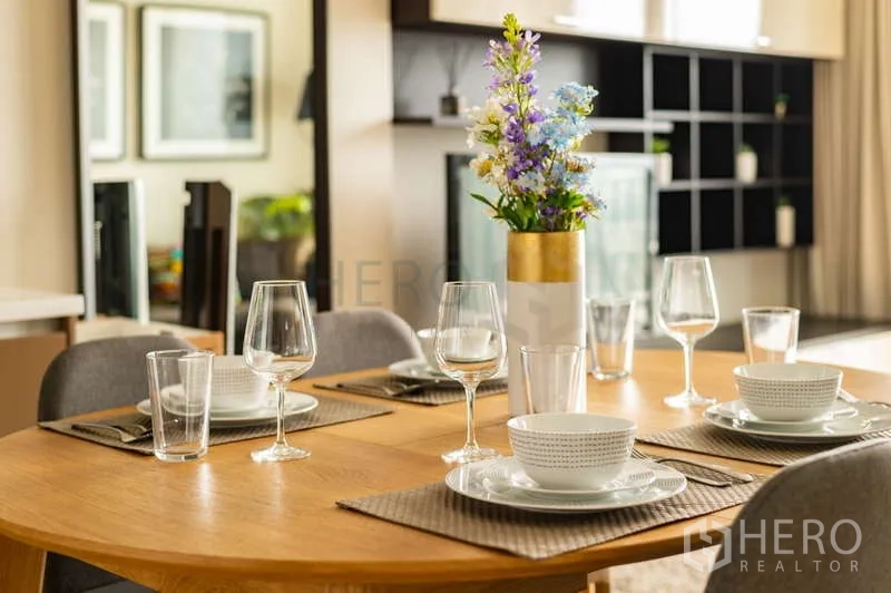 Condominium for sale in Khlong Toei, Bangkok - Close-up of dining table set for four with glasses and tableware in a modern condo.