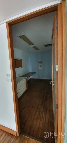 Office Space for rent in Watthana, Bangkok - Compact private office with built-in cabinets, desk, and recessed ceiling lights.