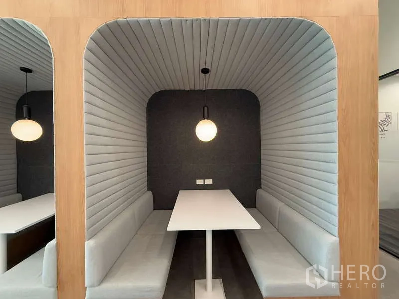 Office Space for rent in Huai Khwang, Bangkok - Acoustic booth seating with padded walls, pendant light and white table for private discussions.