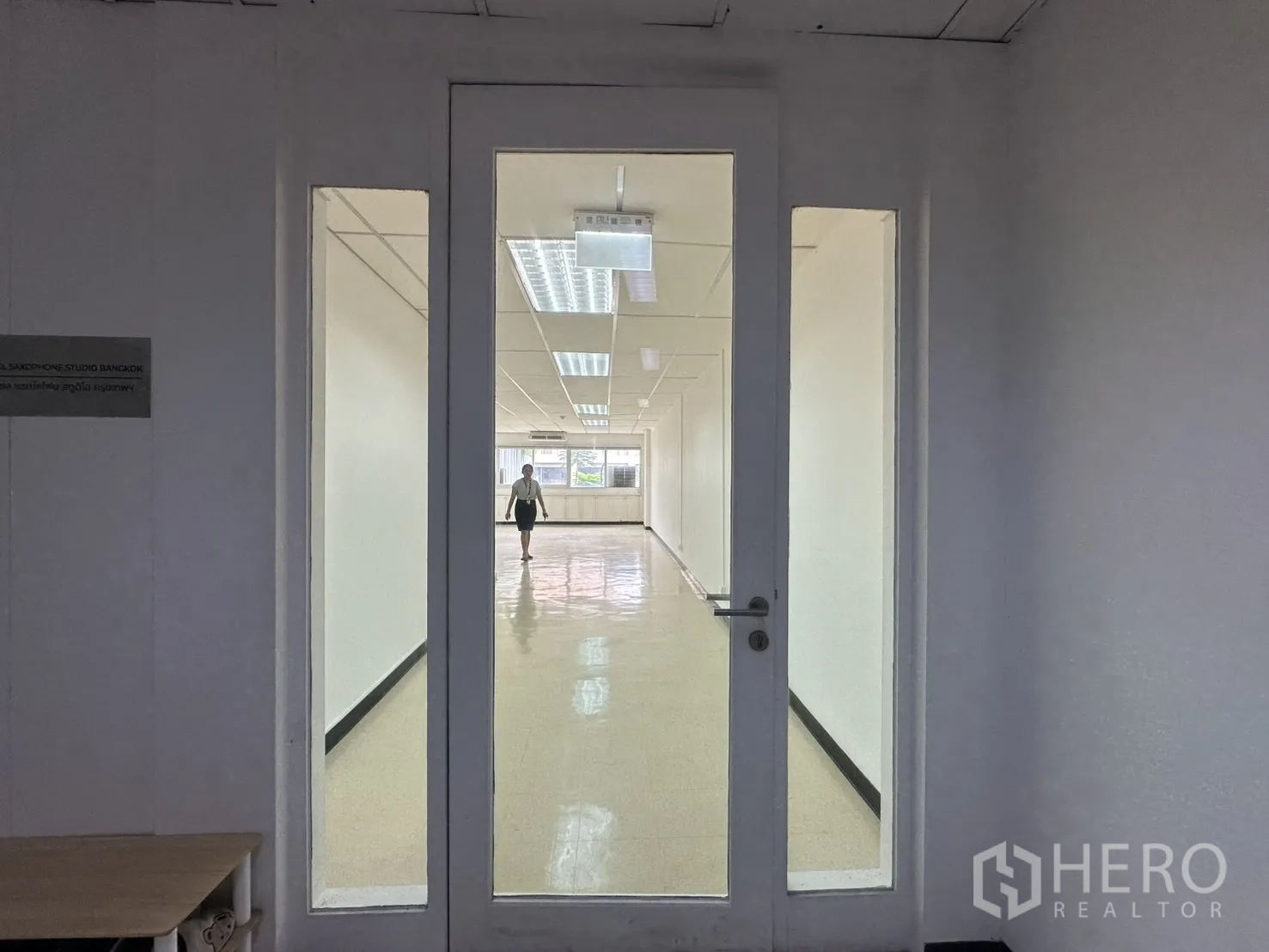 ออฟฟิศ for rent in Pathum Wan, Bangkok - ประตูกระจกทางเข้าแบบมีช่องแสงด้านข้าง เปิดสู่พื้นที่ออฟฟิศโอเพนสเปซยาว.