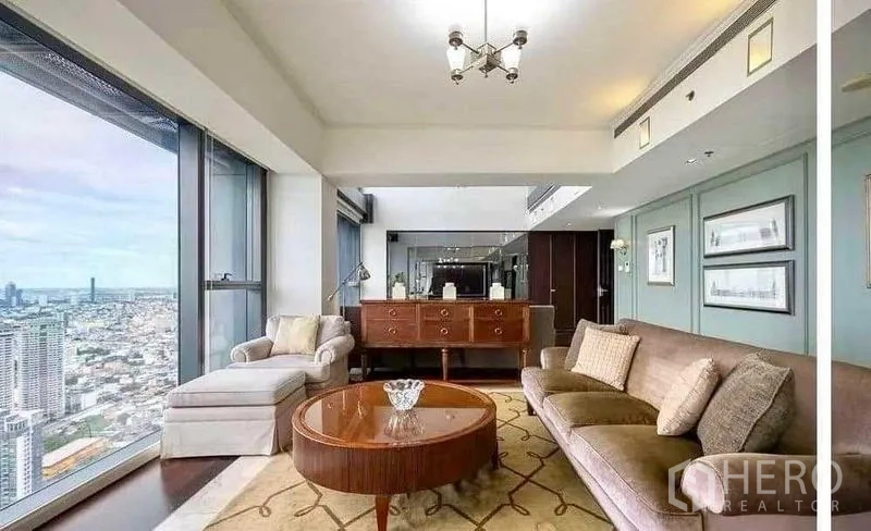 Condominium for rent - Elegant sitting room with sideboard, armchair and picture windows.