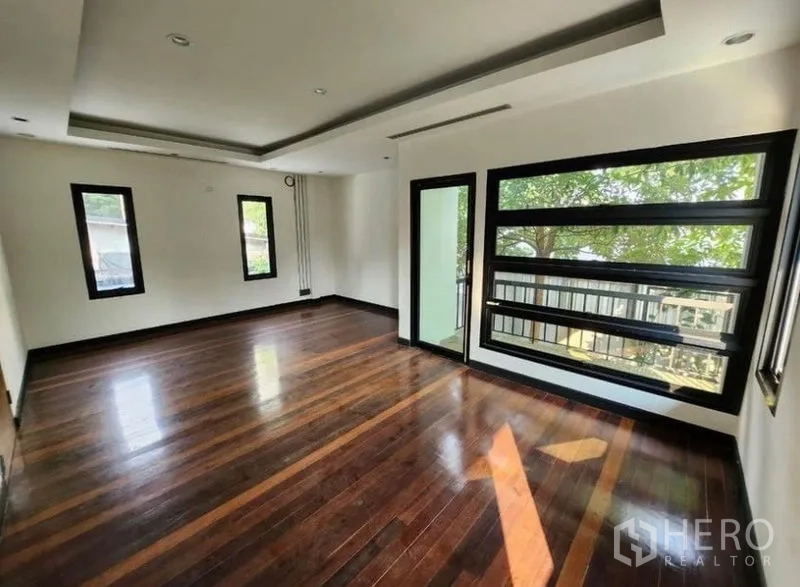 带办公室的家 出租在Lat Phrao, Bangkok - 采光充足的办公室房间，深色实木地板、内嵌式吊顶，大窗眺望绿意。