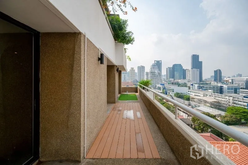 Condominium for sale - Long balcony walkway with railing and skyline views.