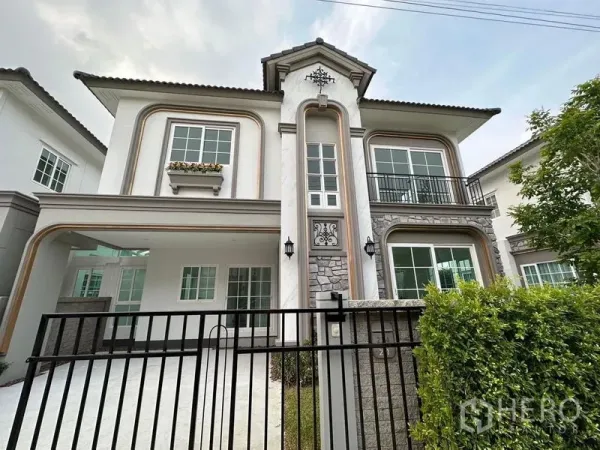 Detached House for rent - Two-storey detached house exterior with balcony, gated front, and stone trim.