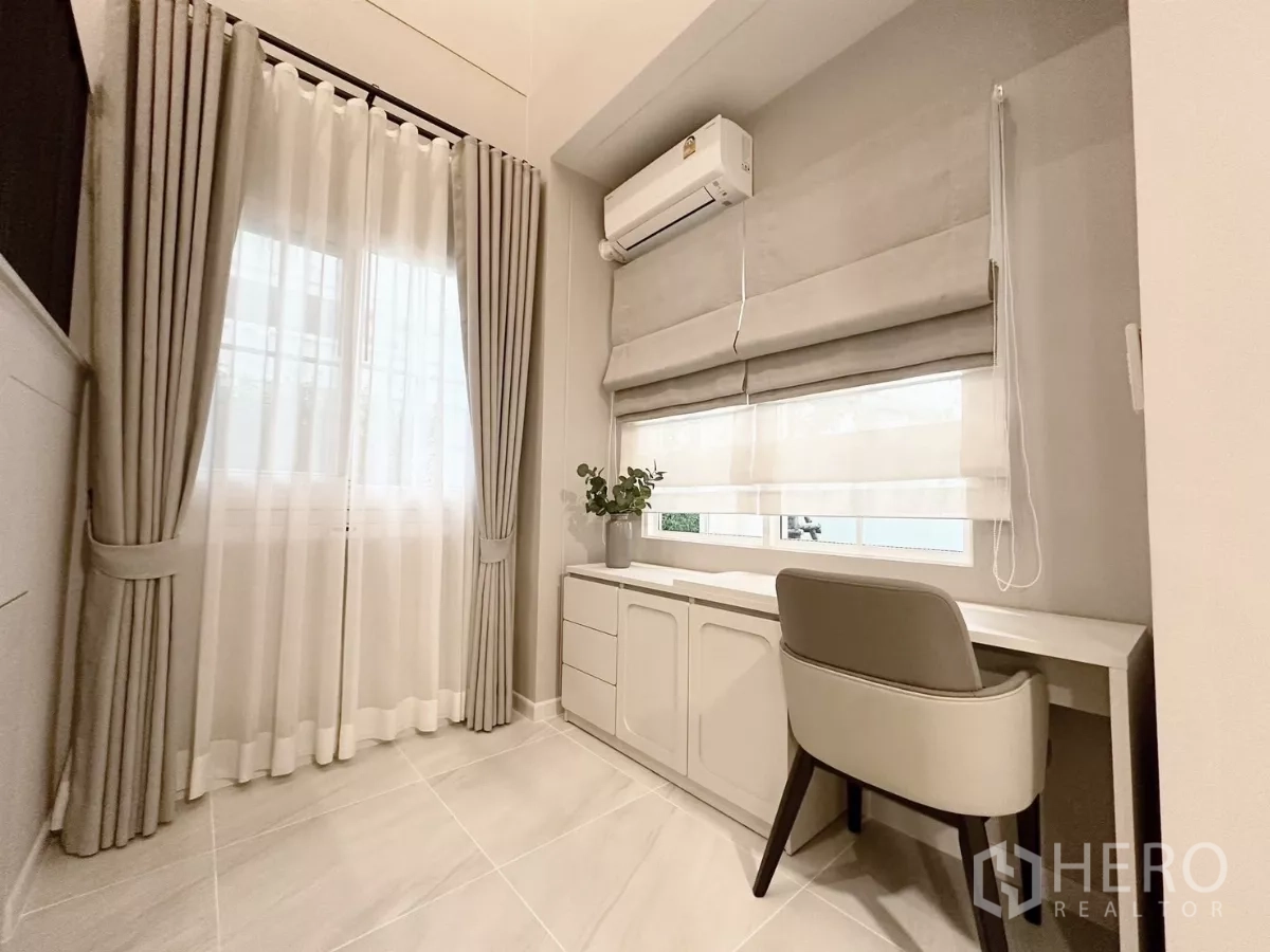 Detached House for rent in Bang Phli, Samut Prakan - Ground-floor study nook with built-in desk, air conditioner, and double curtains.