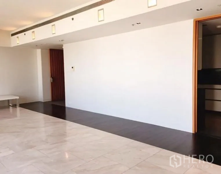 公寓 出租或出售在Sathon, Bangkok - 高楼层公寓的客厅，浅色大理石地板与深色木地带。