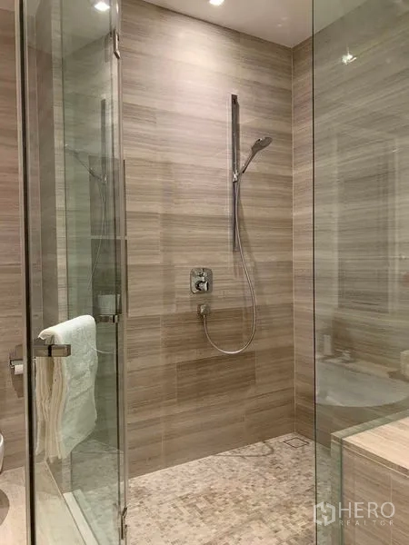Condominium for rent in Watthana, Bangkok - Glass-enclosed walk-in shower with rainfall showerhead and stone-tile floor.