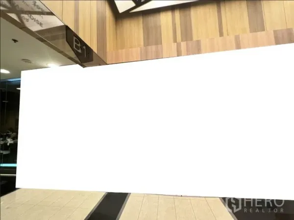 零售空间 出租在Watthana, Bangkok - 商场B1层店面外立面，木质墙面与瓷砖走廊。