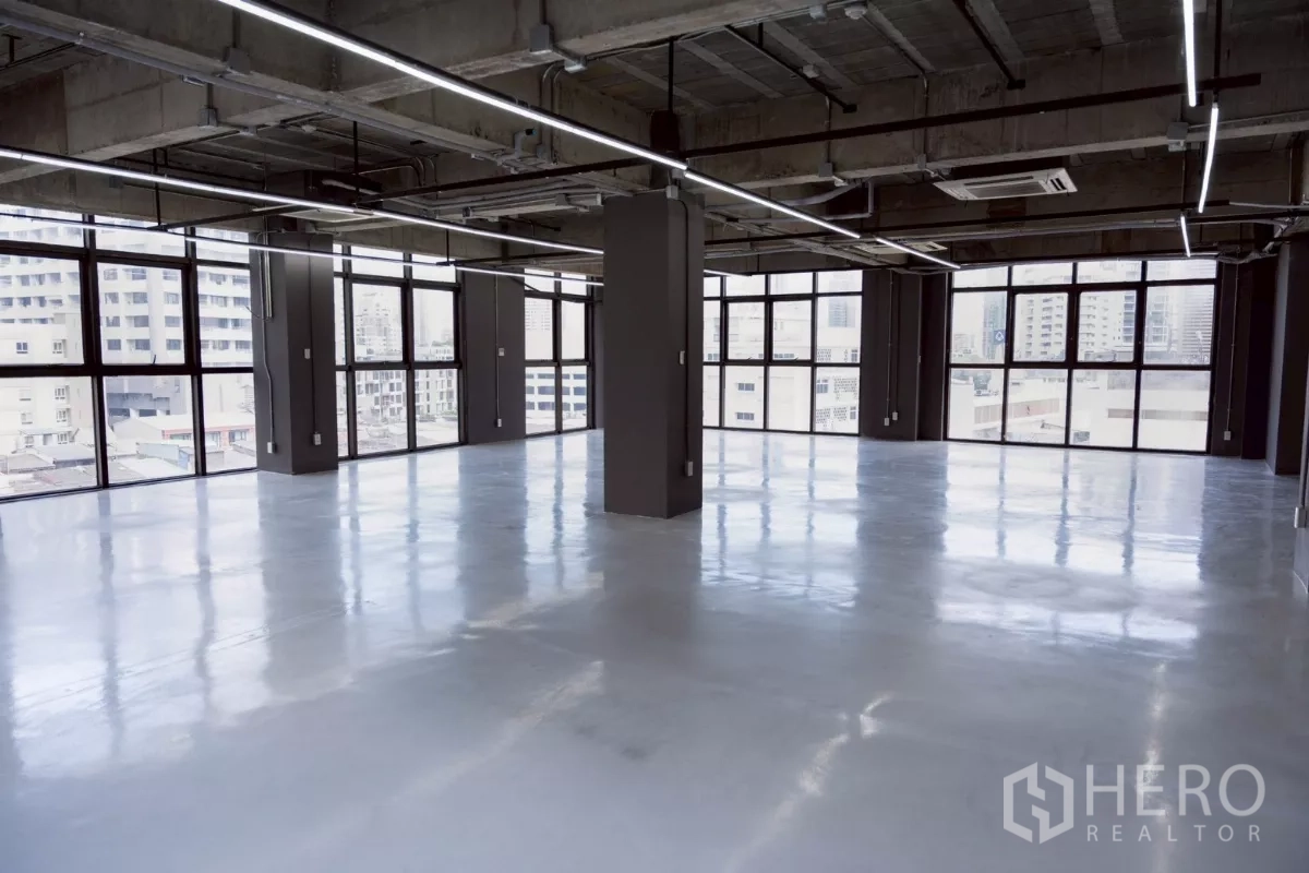 Office Space for rent - Large industrial-style workspace with wraparound windows and panoramic city views.