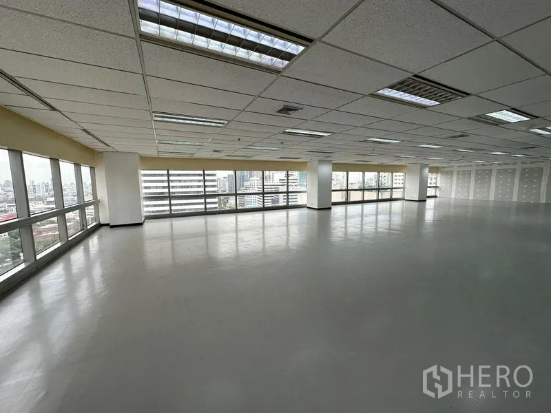 Office Space for rent - Bright corner office space with panoramic Bangkok skyline through wide windows.