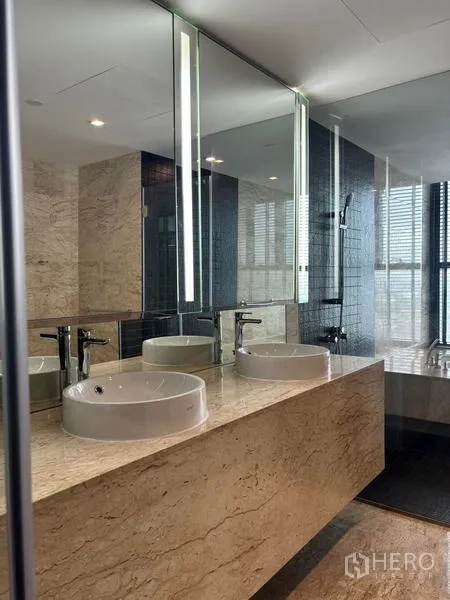 Condominium for rent - Luxurious bathroom with marble double vanity and large mirrors.
